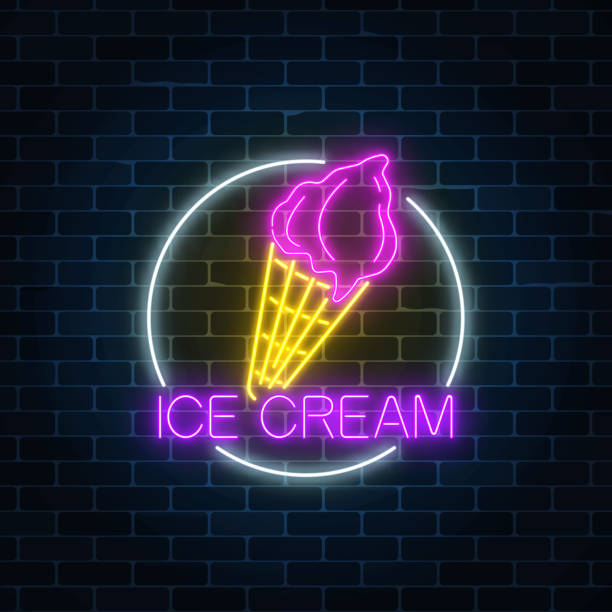 istock Neon glowing sign of cake with glaze in circle frame on a dark brick wall background. 957087236