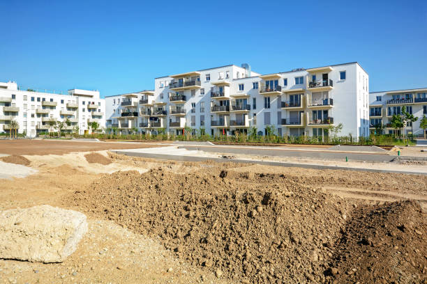 istock Urban development with construction site and new residential buildings 957087402
