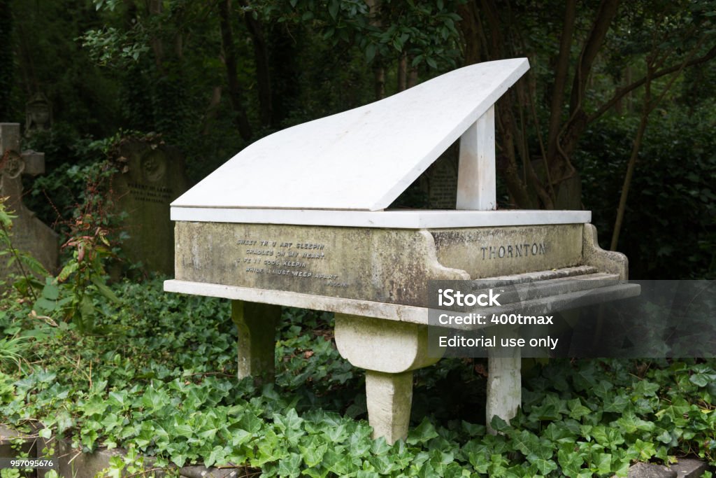 Highgate Cemetery London, USA - Aug 3, 2017: A unique Piano grave stone at the historic Highgate cemetery late in the day. Capital Cities Stock Photo