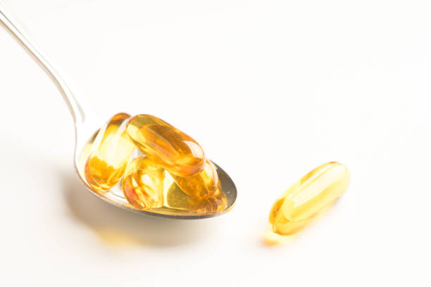 istock fish oil capsules in a spoon on white background 957099720