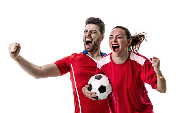 istock Young couple fan in red uniform celebrating 957101472