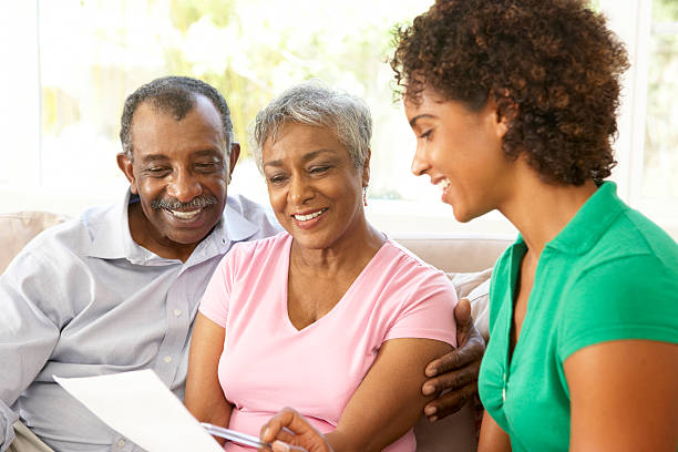 istock Senior Couple Talking To Financial Advisor At Home 95710377