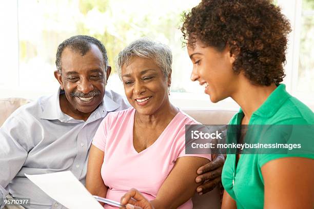 Senior Couple Talking To Financial Advisor At Home Stock Photo - Download Image Now - Senior Adult, Discussion, Finance