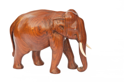 Carved wooden Elephant statue isolated on a white background, a sign of good luck