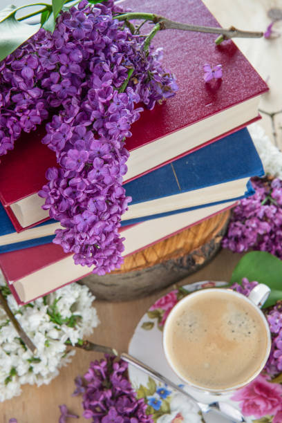 istock Spring mood, background. Books ,coffee, and branches of lilac 957104584