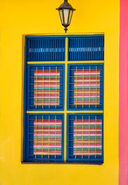 Photo of a wooden window painted with various colors, clicked in the historic center of Fortaleza, Ceará