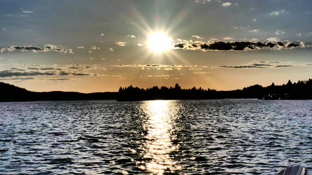istock Sun and its luminous halo on the water 957115506