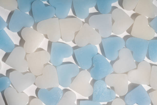 istock mini blue and white candle heart on white isolated background top view. 957119638