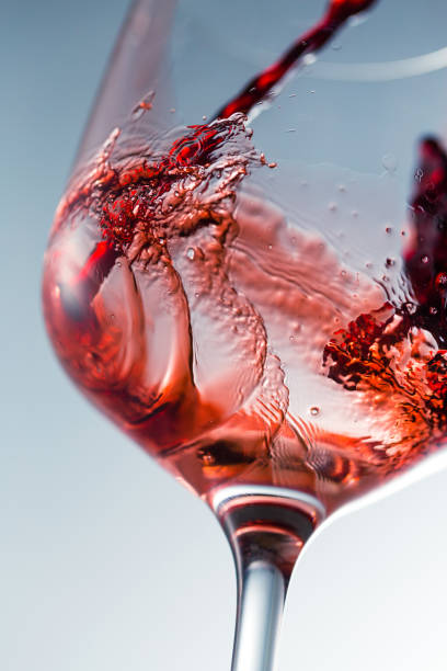 istock Red wine pouring in glass 957119932