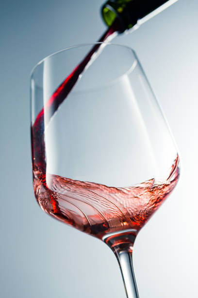 istock Red wine pouring in glass 957119936