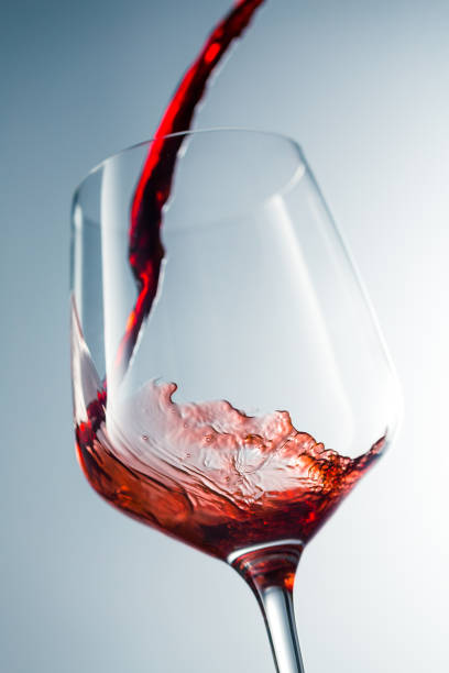 istock Red wine pouring in glass 957119990