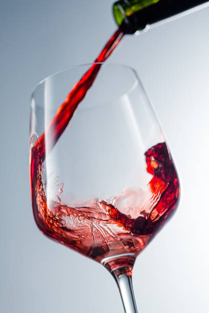 istock Red wine pouring in glass 957120008