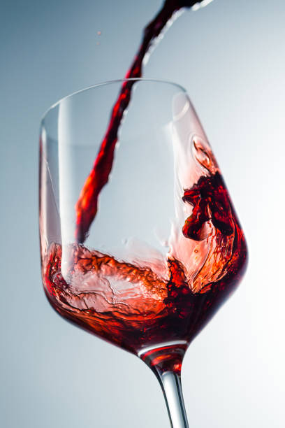 istock Red wine pouring in glass 957120032