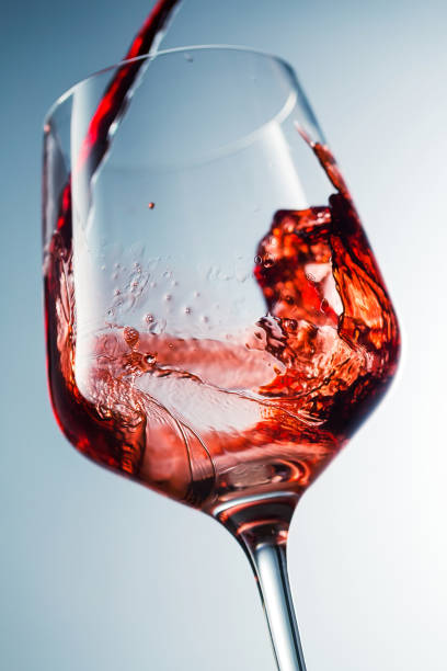 istock Red wine pouring in glass 957120048