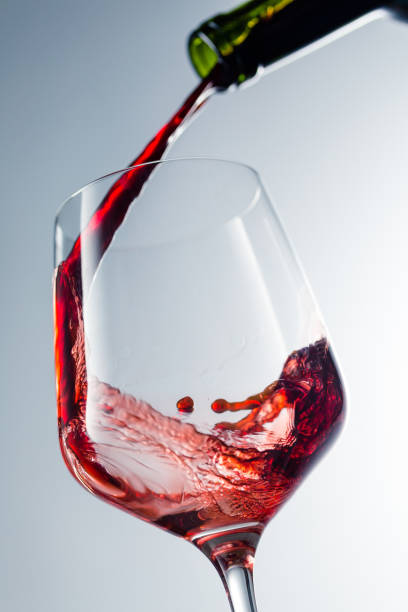 istock Red wine pouring in glass 957120168