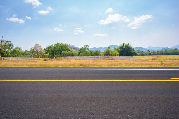 istock Asphalt road and countryside views 957120902