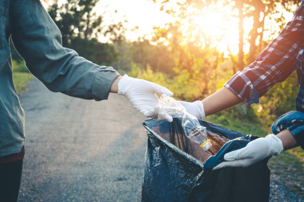 istock Women volunteer help garbage collection charity environment. 957121288