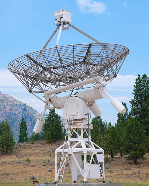 istock Giant parabolic antenna looking into blue sky 95712373