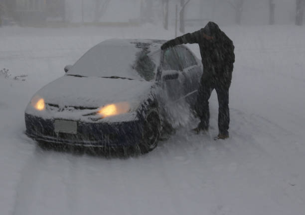istock Clearing Snow off the Car 957124718