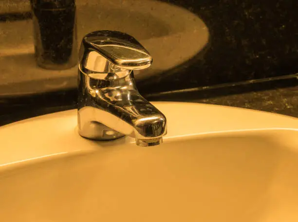 Photo of Vintage tone of faucet in toilet