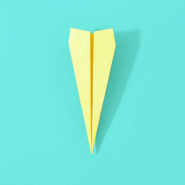 istock Top view creative travel background concept. Flat lay yellow paper plane on pastel background with copy space 957125924