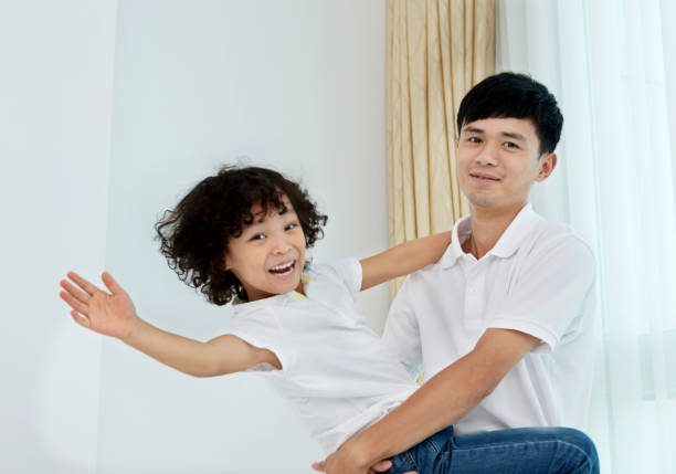 istock Father carrying his son at home 957126092