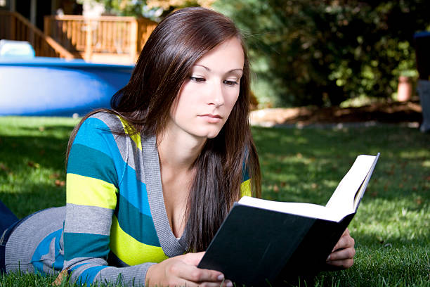 istock Beautiful Girl in the Park Reading a Book 95712661