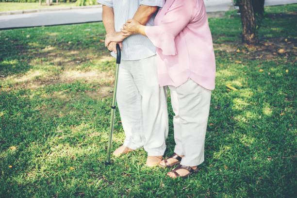 istock Senior man walking with wooden stick 957128354