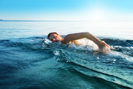 Young man swimming in the ocean