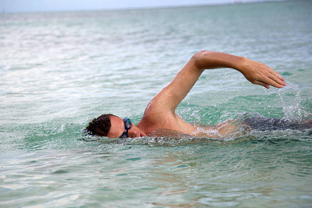 istock young man swiming in oceans water 95712876