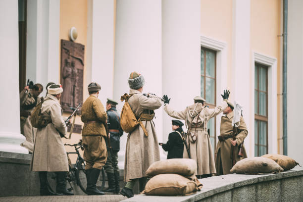 Gomel, Belarus. Celebration For The Century Of October Revolution. Reenactors In The Form Of Bolsheviks Soldiers Occupying Palace Gomel, Belarus. Celebration For The Century Of October Revolution. Reenactors In The Form Of Bolsheviks Soldiers Occupying Palace. historical reenactment stock pictures, royalty-free photos & images
