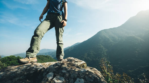 istock successful hiker stand on sunrise mountain top cliff edge 957129958