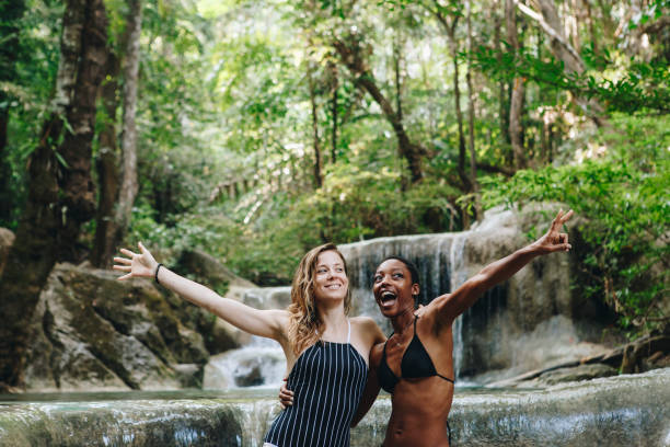 istock Women couple enjoying the waterfall 957130740