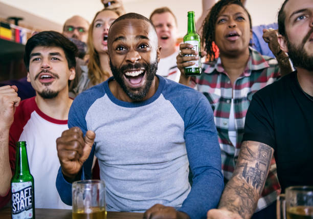 istock Friends cheering sport at bar together 957131198