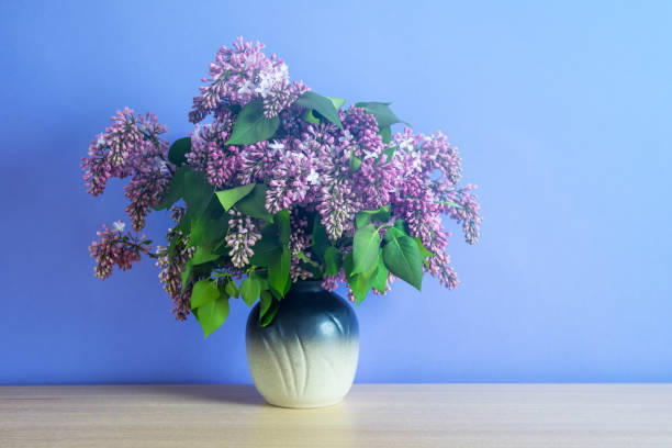 istock Bouquet of lilacs on blue background 957134840