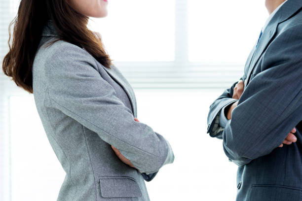 istock Two businesspeople standing face to face 957139196