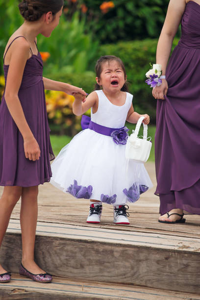 Crying flower girl walking down Asian flower girl being shy flower girl stock pictures, royalty-free photos & images