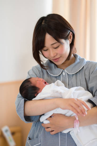 istock mother embracing newborn baby 957139294