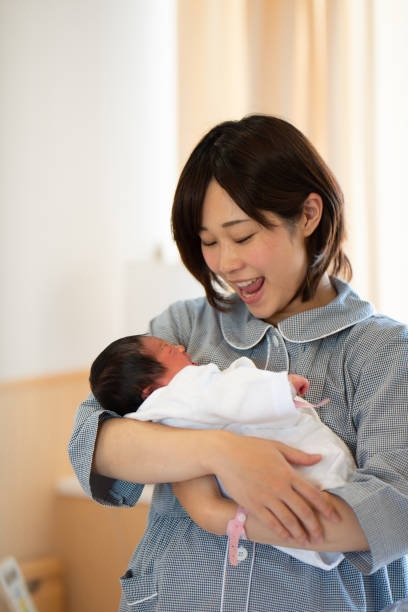 istock mother embracing newborn baby 957139302