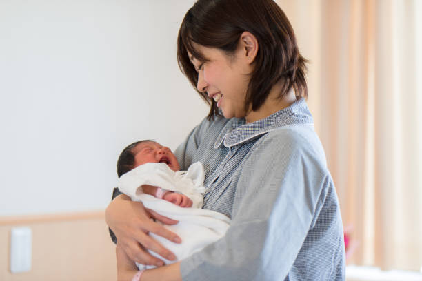 istock mother embracing newborn baby 957139308