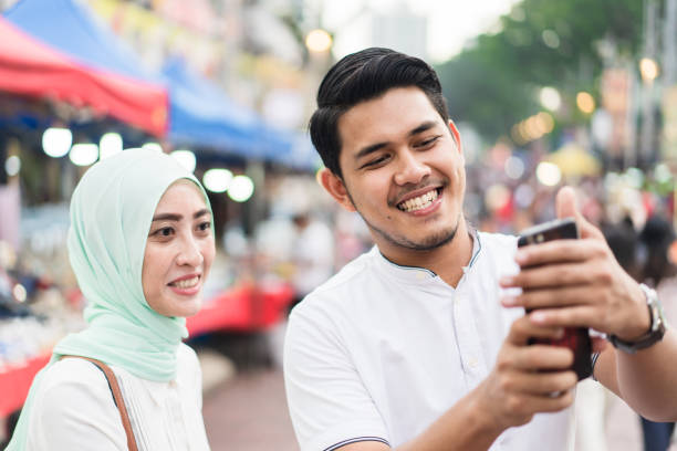 istock Couple in market enjoying outdoors and taking selfie. 957139908