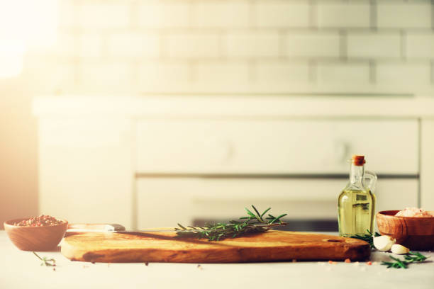 istock Food cooking ingredients on white kitchen design interior background with rustic wooden chopping board in center, copy space 957139946