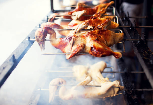 istock Appetizing grilled duck on the spit skewer. Roasted on traditional barbecue. Roasting prepared ram duck baked meat 957139952
