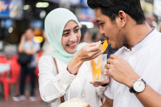 istock Muslim couple enjoying a playful moment while sharing food. 957139954