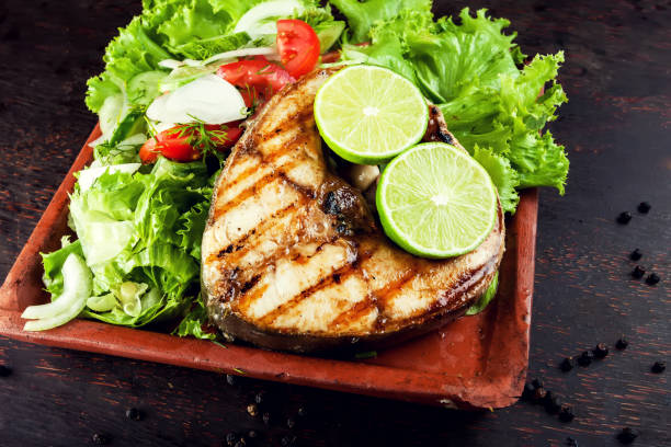 istock Grilled Fish Fillet with Vegetables in the plate 957140126