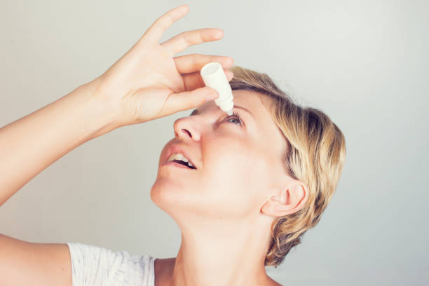 istock a woman using eye drops in eyes 957140646