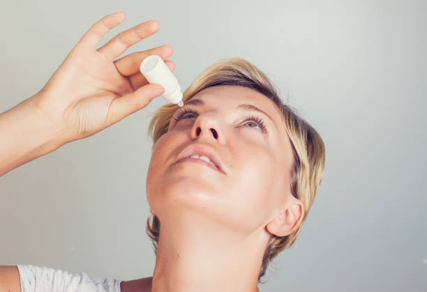 istock a woman using eye drops in eyes 957140666
