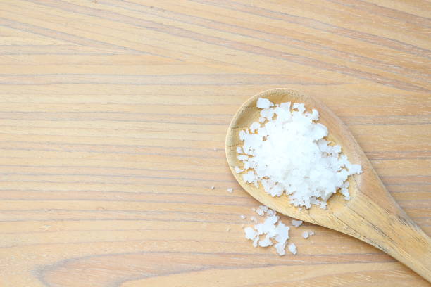 istock Table salt on wooden ladle 957141660