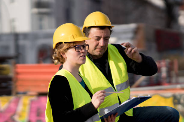 istock Male and female coworkers on construction site 957144778