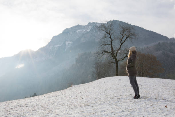 istock Woman walks up snowy mountain slope 957154580